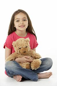 Studio Portrait Of Smiling Girl with Teddy Bear