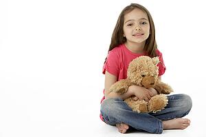 Studio Portrait Of Smiling Girl with Teddy Bear
