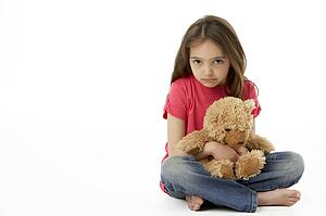 Studio Portrait Of Smiling Girl with Teddy Bear