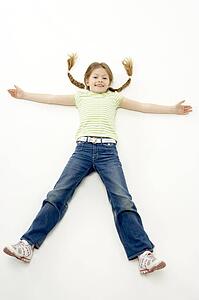 Studio Portrait of Smiling Girl lying down with arms and legs spread