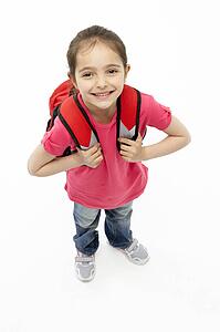 Studio Portrait of Smiling Girl Wearing School Bag
