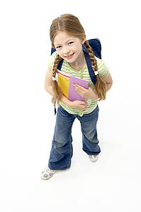 Studio Portrait of Smiling Girl Holding School Book