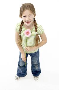Studio Portrait of Smiling Girl Holding Flower