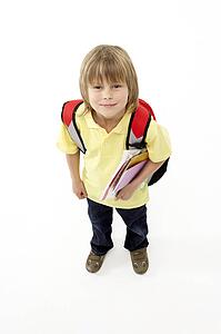 Studio Portrait of Smiling Boy Holding Books