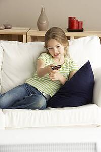 Young Girl Watching Television at Home