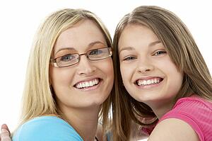 Studio Portrait of Smiling Teenage Girl with older Sister