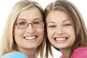 Studio Portrait of Smiling Teenage Girl with older Sister