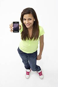 Portrait of Smiling Teenage Girl Holding Mobile Phone