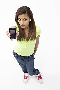 Portrait of Smiling Teenage Girl Holding Mobile Phone