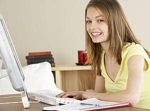 Smiling Teenage Girl Studying at Home