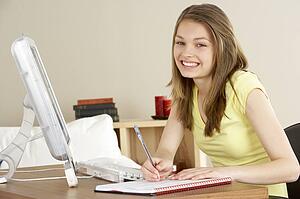 Smiling Teenage Girl Studying at Home