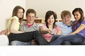 Teenage Friends Watching Television at Home