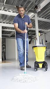 Cleaner mopping office floor