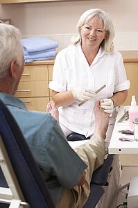 Chirpodist treating client in clinic