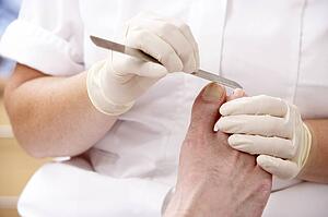 Chirpodist treating client in clinic