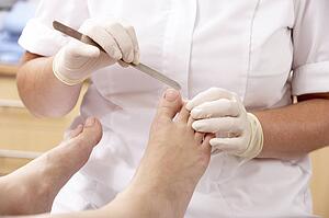 Chirpodist treating client in clinic