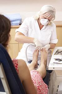 Chirpodist treating client in clinic