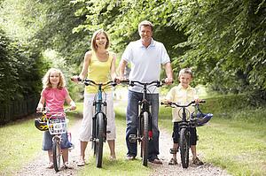 Family riding bikes in countryside
