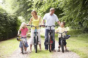 Family riding bikes in countryside