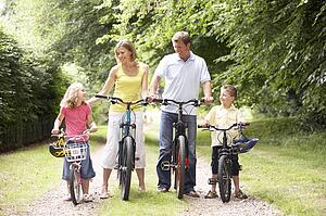 Family riding bikes in countryside