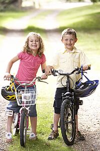 Children riding bikes in countryside