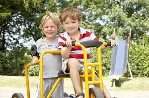 Two Young Boys Playing on Bike