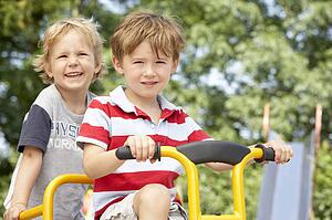 Two Young Boys Playing on Bike