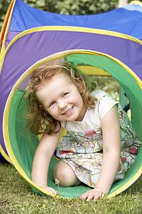 Young Girl Crawling Through Play Equipment