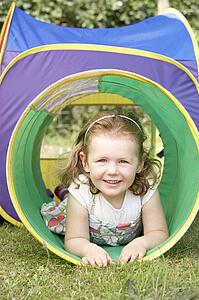 Young Girl Crawling Through Play Equipment