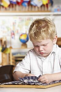 Adult Helping Two Young Children at Montessori/Pre-School