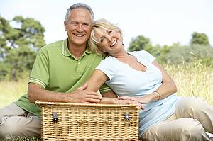 Mature couple having picnic in countryside