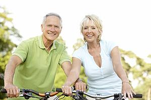 Mature couple riding bikes