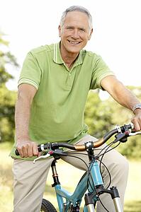 Portrait of man riding cycle in countryside