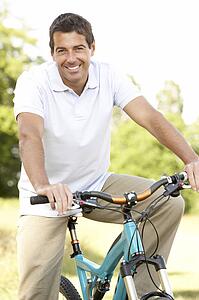 Young man riding bike in countryside