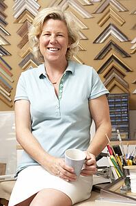 Female picture framer at work