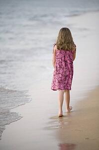 Girl walking on beach, Maui, Hawaii, USA