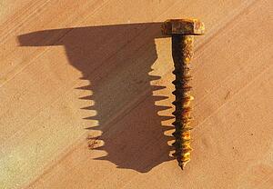 Rusty screw with shadow
