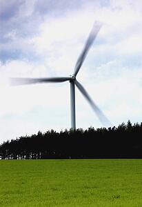 Wind turbine behind a field of grass, North Yorkshire, England