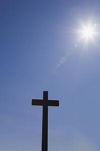 Silhouetted cross and sunburst