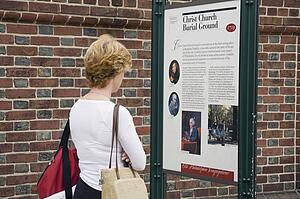Woman reading park information sign