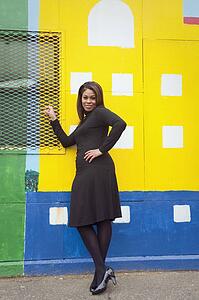 Woman standing in front of a city mural