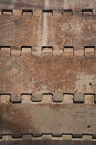 Close-up of a rusted steel track wheel on a excavator