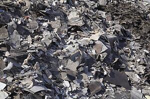 Pile of discarded asphalt roofing shingles in a recycling yard, Laval, Quebec, Canada