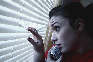 Teenage girl on the phone, looking out the window