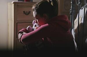 Teenage girl alone in bedroom