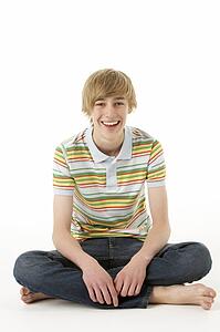 Studio Portrait Of Happy Teenage Boy