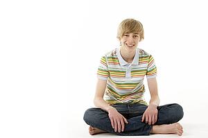 Studio Portrait Of Smiling Teenage Boy