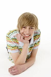 Studio Portrait Of Happy Teenage Boy