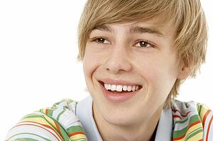 Studio Portrait Of Smiling Teenage Boy