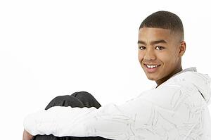 Studio Portrait Of Smiling Teenage Boy
